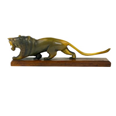 Lot 414 - A Chinese carved horn model of a lion, early 20th century.