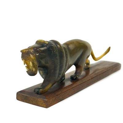Lot 414 - A Chinese carved horn model of a lion, early 20th century.