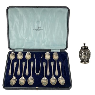 Lot 11 - A George V silver teaspoon set for eleven (one spoon missing) within fitted box by Walker & Hall.