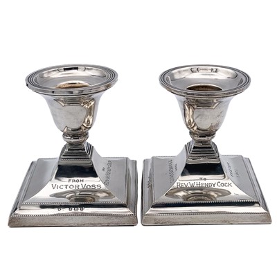 Lot 47 - A pair of George V silver squat candlesticks.