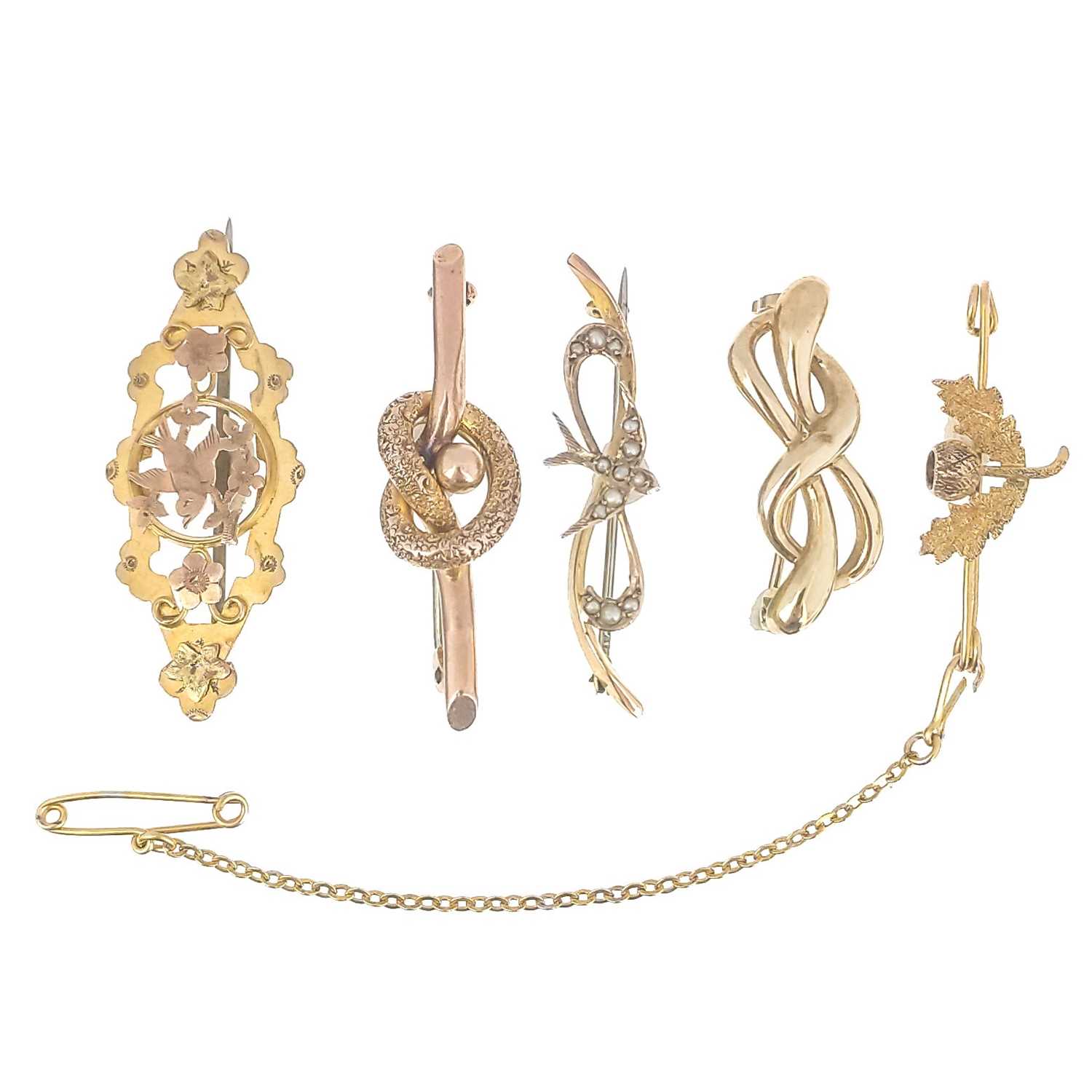 Lot 306 Five 9ct gold brooches.