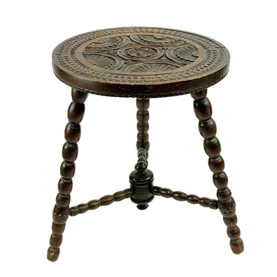 Lot 193 - A Victorian carved circular tripod table.