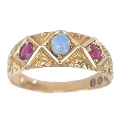 Lot 311 - A Victorian 18ct opal and garnet set three stone ring.