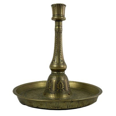 Lot 190 - An Indian engraved brass candle stand, 18th/19th century.