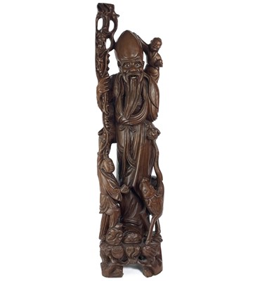 Lot 84 - A Chinese carved wood figural lamp base, 19th century.