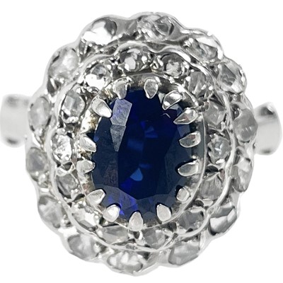 Lot 227 - An Eastern white metal diamond and sapphire cluster ring.