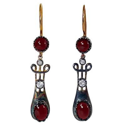 Lot 233 - A pair of 9ct gold and silver gilt drop earrings set with garnets and diamonds.