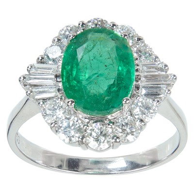 Lot 296 - An attractive 18ct white gold emerald and diamond cluster ring.