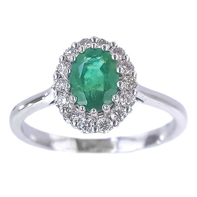 Lot 349 - An 18ct white gold oval emerald and round brilliant cut diamond cluster ring.