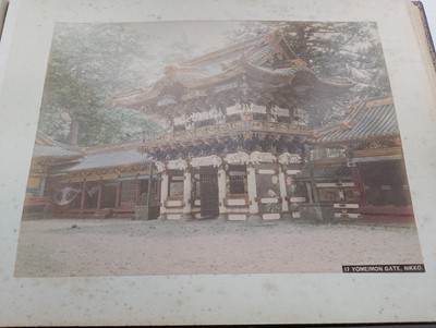 Lot 260 - A Japanese photo album containing 50 hand coloured images, circa 1900.