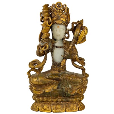 Lot 1282 - A Chinese white and gilded jade seated Buddha, 18th/19th century.