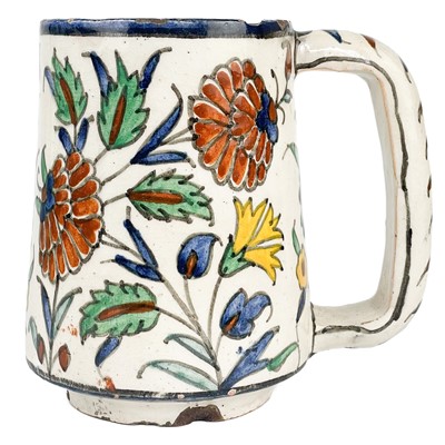 Lot 225 - An Iznik style pottery mug, possibly Palestine, late 19th/early 20th century.