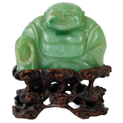 Lot 74 - A Chinese green jade small carving of a seated Buddha with prayer beads.