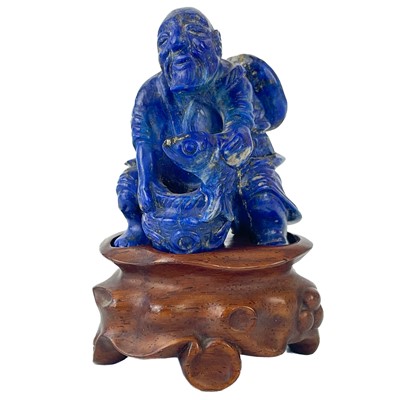 Lot 75 - A Chinese lapis lazuli small carved figure of a fisherman.