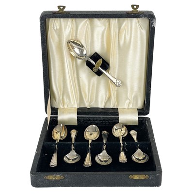 Lot 78 - A George V silver cased set of seven golfing teaspoons by Walker & Hall.