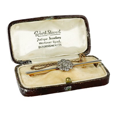 Lot 22 - An early 20th century gold and platinum diamond cluster bar brooch.