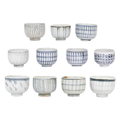 Lot 486 - Eleven Japanese blue and white porcelain tea bowls, 19th century.