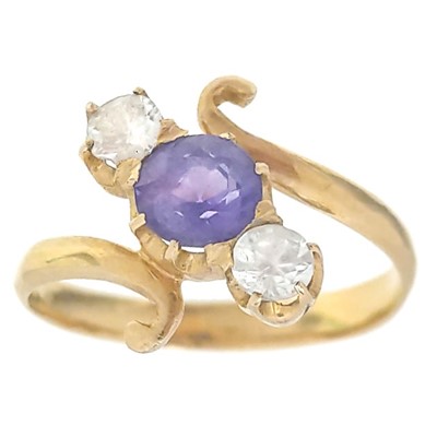 Lot 65 - A high purity gold (tests 18ct) sapphire and white topaz set three-stone crossover ring