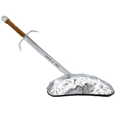 Lot 177 - A .999 fine silver and 925 silver 'Sword In The Stone' paper knife and stand by James Suddaby.