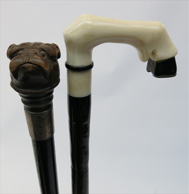 Lot 409 - A Victorian ebonised walking cane, the carved...