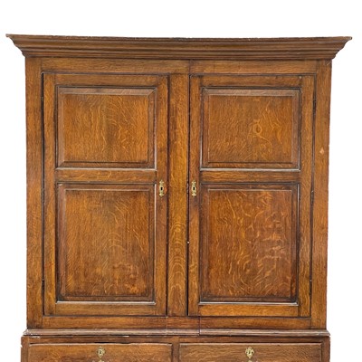 Lot 48 - A George III oak livery cupboard or wardrobe.