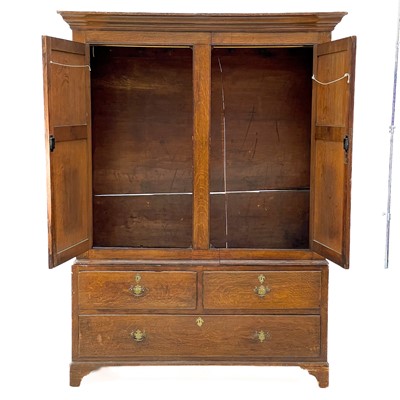 Lot 48 - A George III oak livery cupboard or wardrobe.