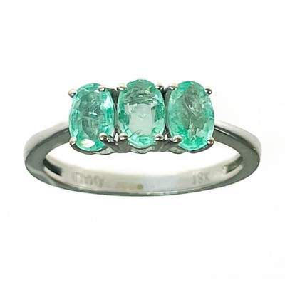 Lot 402 - An 18ct white gold Colombian emerald set three-stone ring by Iliana.