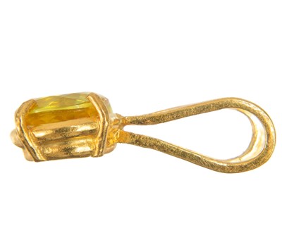 Lot 420 - A 24ct yellow sapphire set pendant by James Suddaby.