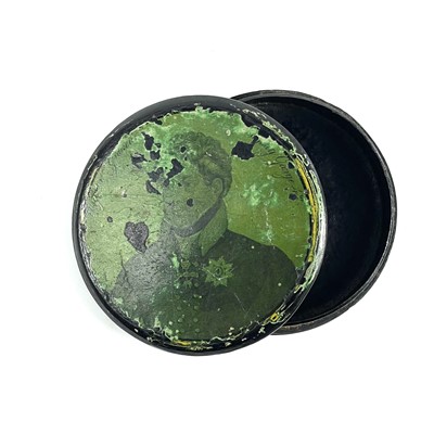 Lot 91 - A George IV lacquered papier mache circular portrait snuff box.