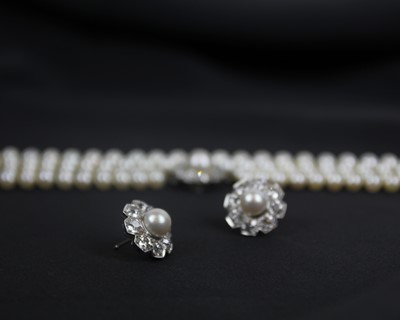 Lot 217 - An impressive early 20th century cultured pearl, diamond set, double-row necklace & earrings suite.