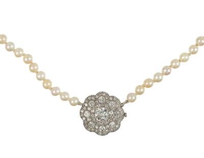 Lot 437 - An early 20th century graduated natural saltwater and cultured pearl necklace set a 1ct old mine cut diamond.