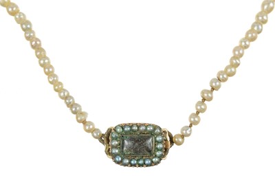 Lot 444 - A Georgian graduated natural saltwater pearl necklace with rose gold seed pearl and hair panel clasp.