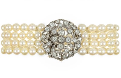 Lot 438 - An early 20th-century cultured pearl four-row bracelet with diamond set clasp.