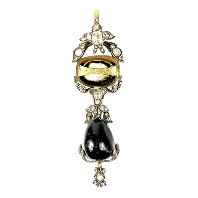 Lot 125 - A Victorian cabochon garnet and diamond pendant with hair locket back.