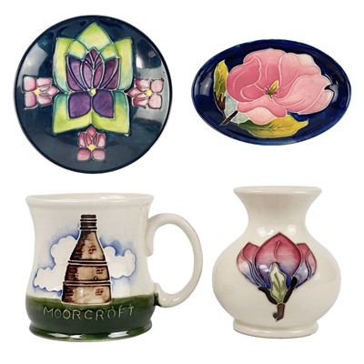 Lot 495 - A Moorcroft pottery mug, a vase and two dishes.