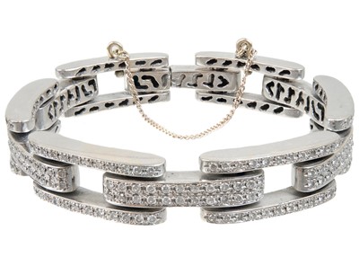 Lot 446 - A contemporary heavy 18ct white gold diamond pave set bracelet.