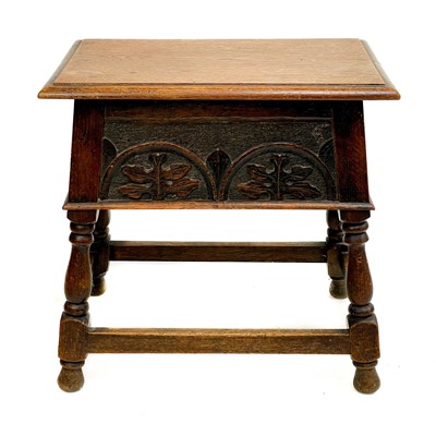 Lot 88 - A carved oak stool.