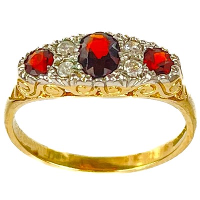 Lot 463 - A 9ct garnet and diamond set seven stone ring.