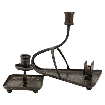 Lot 142 - An Arts and Crafts wrought steel candle holder in the manner of Goberg.