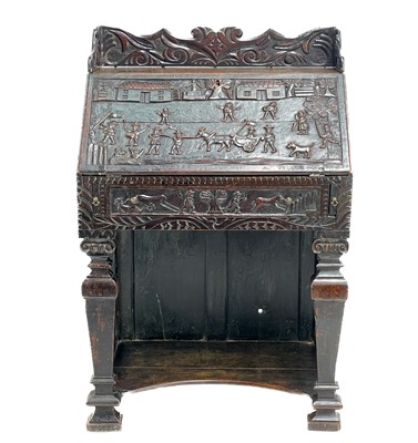 Lot 11 - An unusual carved oak bureau.