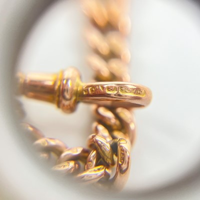 Lot 93 - A 9ct rose gold graduated curb link Albert watch chain.
