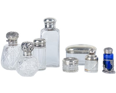 Lot 137 - A collection of eight assorted silver-topped dressing table jars.