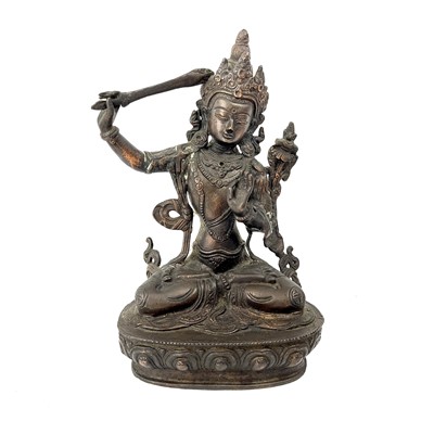 Lot 1116 - A Tibetan bronze figure of Manjushri.