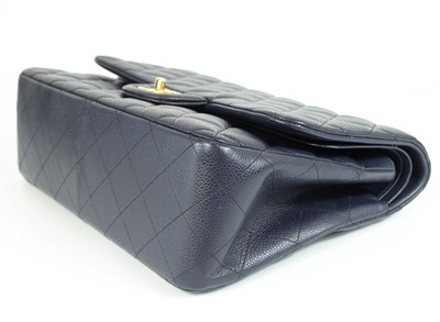 Lot 577 - A Chanel Maxi navy blue caviar leather handbag.