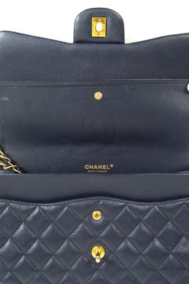 Lot 577 - A Chanel Maxi navy blue caviar leather handbag.