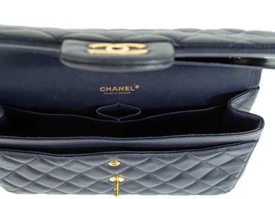 Lot 577 - A Chanel Maxi navy blue caviar leather handbag.