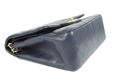 Lot 577 - A Chanel Maxi navy blue caviar leather handbag.