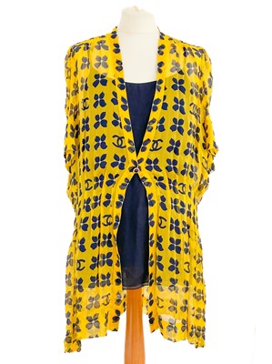 Lot 570 - A Chanel yellow and black silk dress and navy blue blouse.