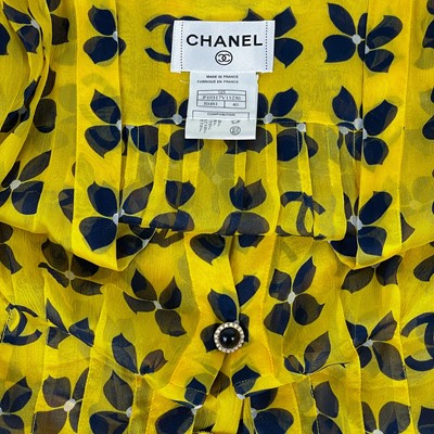 Lot 570 - A Chanel yellow and black silk dress and navy blue blouse.