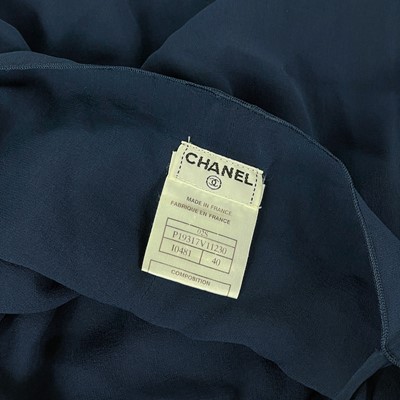 Lot 570 - A Chanel yellow and black silk dress and navy blue blouse.